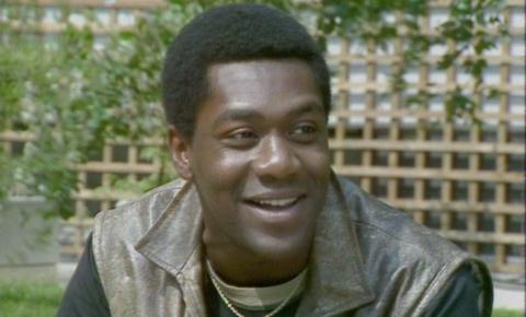 Lenny Henry talking while sitting in a garden