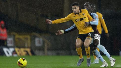 Wolves' Joao Gomes competing with Aston Villa's Amadou Onana