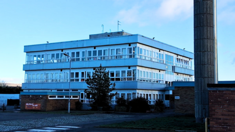 A three-storey white and grey primary school building