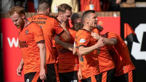 Dundee United celebrate their first Premiership win of the season