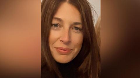 A picture of Gemma Reeves who started the petition. Gemma has long brown hair and is smiling to camera.