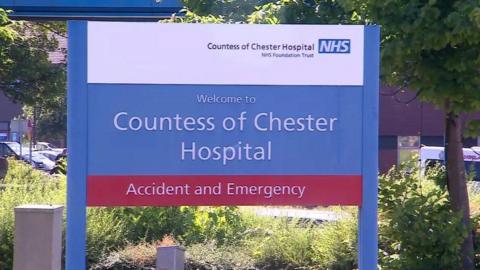 A blue sign, with Countess of Chester Hospital written on in white writing above a red strap-line, which reads Accident and Emergency.