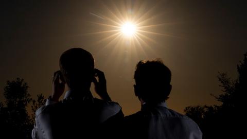 Two people watching the solar eclipse