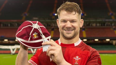Olly Cracknell holds up his first Wales cap