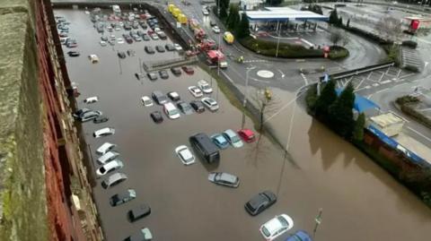 Photograph of cars under water - when the River Tame burst its banks at Meadow Mill in Stockport on New Years Day 2025.