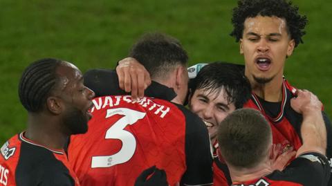 Luton Town players celebrate Liam Walsh's goal against Northampton Town