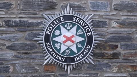 PSNI logo on a brick wall