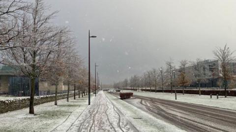 A light covering of snow visible on a street
