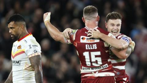 Wigan players celebrate winning the Grand Final