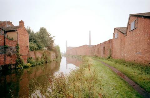 Viewed from the Staffordshire & Worcestershire Canal. The tall chimney is evidence of the steam engine which powered the mill, and the canal provided cheap transport.