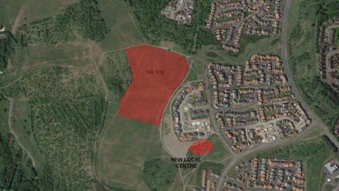 An aerial map marking out the part of land earmarked for the development of 71 homes. It borders with an existing housing development on one side, with open land on the other side. 