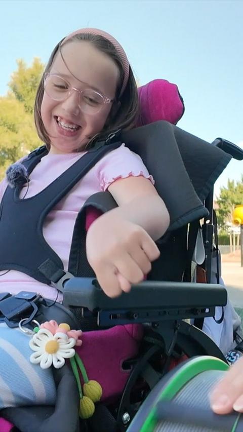 Millie in her chair playing in the park