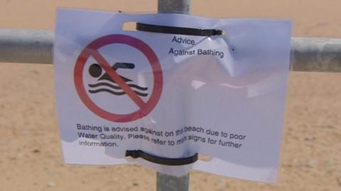 No swimming sign on beach