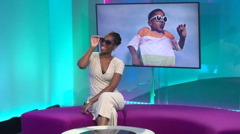 Shanequa in the studio with sunglasses