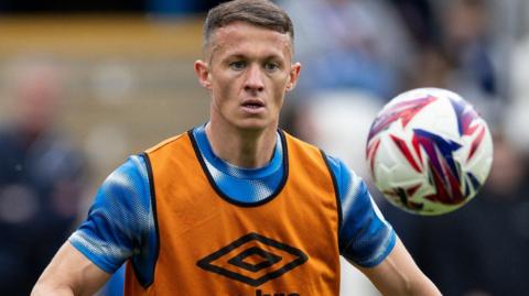 Jonathan Hogg warms up before a match for Huddersfield Town
