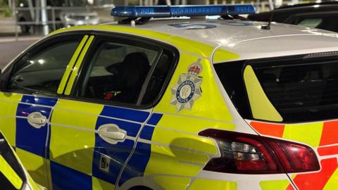 A close up of a police patrol car outside a hospital.
