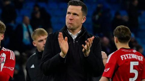 Gary Caldwell applauds the travelling Exeter City fans after the defeat