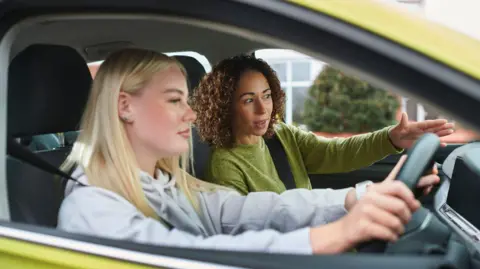 A woman and her driving instructor