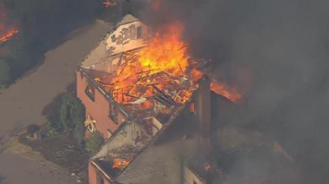 Large flames burn a home