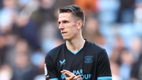 Emil Riis Jakobsen clapping at the end of a match for Preston