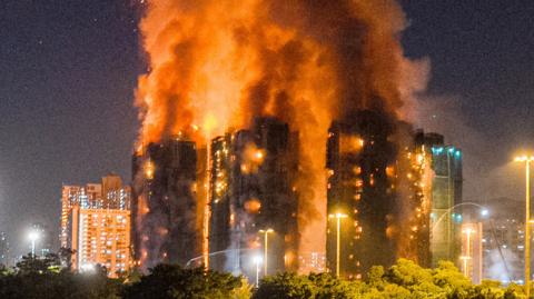 The Wang Fuk Court complex on fire. Three tower blocks can be seen engulfed in flames