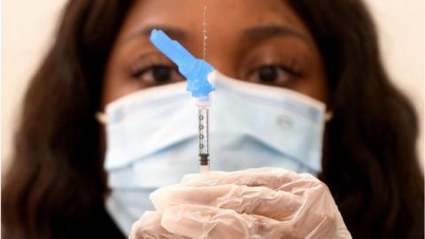 Nurse holds the J&J vaccine