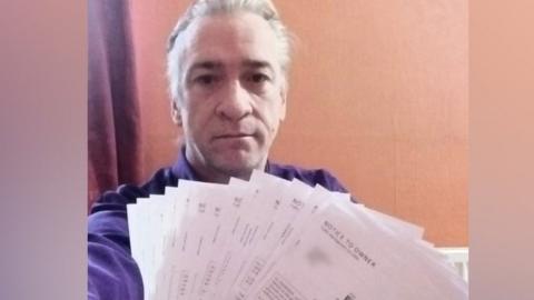 Tony Hawkins with some of his parking fines