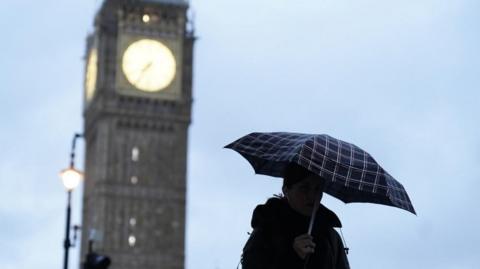 Woman with umbrella near Elizabeth Tower
