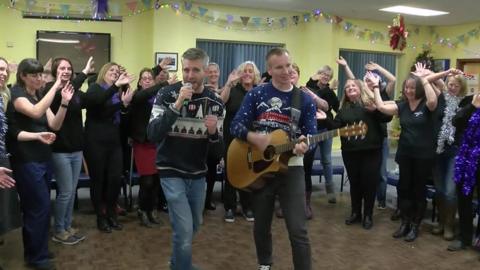 Lt Cdr Phil Clark (R) and Lt Cdr Dave Emery with the Culdrose Military Wives Choir