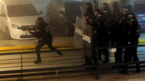 Spanish National Police riot officers charge at demonstrators during the rally called by the group called "Tsunami Democratic" (Democratic Tsunami) for "shutting-down" Barcelona-El Prat international airport