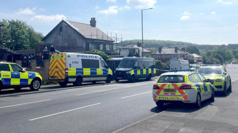 Police cars outside a house