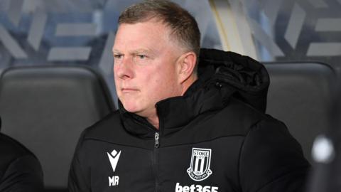 Mark Robins watching his Stoke City side from the dugout