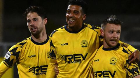Louis Dennis celebrates scoring for Torquay United