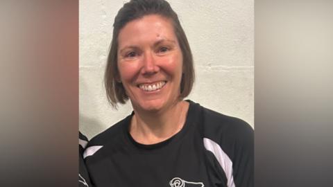 A woman in a Derby FC training top