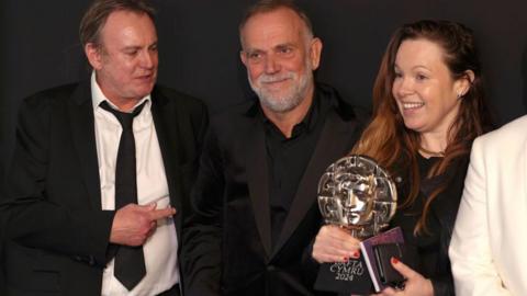  Philip Glenister, Marc Evans and Hannah Thomas pose with the Television Drama Award for 'Steeltown Murders' backstage 