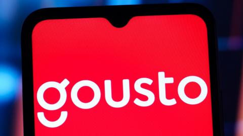The white Gousto logo on a red background on a mobile phone