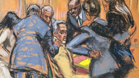 A court sketch showing defence lawyers comfort Sean "Diddy" Combs 