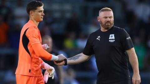 Wayne Rooney shakes Michael Cooper's hand after a pre-season game