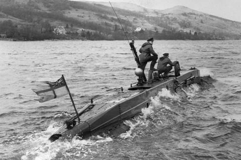 Two submariners on a partly submerged mini submarine X-Craft