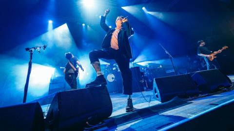 Members of Blur performing on stage in Wolverhampton