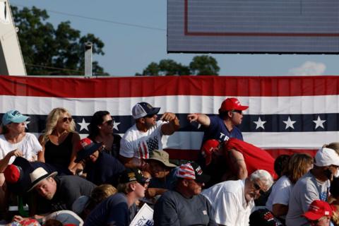 People point after the shooting at a Trump rally