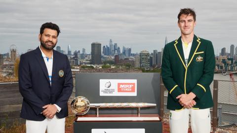 Rohit Sharma, captain of India poses with Pat Cummins, captain of Australia and the ICC World Test Championship mace prior to the ICC World Test Championship Final 2023 at Battersea Power Station on June 05, 2023 in Battersea, England.