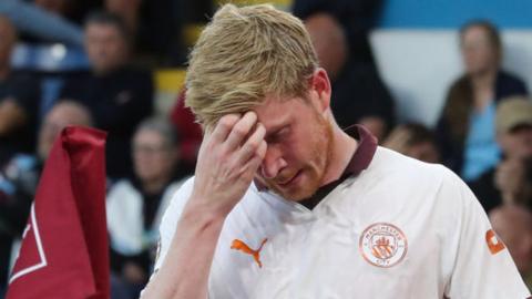 Kevin De Bruyne looks dejected after he goes off injured