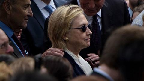 Hillary Clinton stands at the 9/11 memorial service.