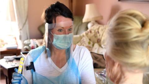 Right At ˿ care worker Sarah Cox does the nails of client Patricia Taylor at her home during the coronavirus pandemic