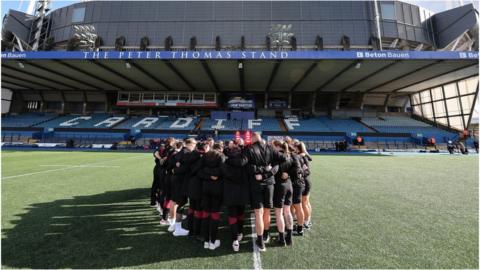 Wales players huddle at the Arms Park