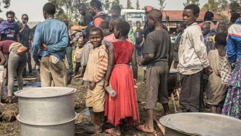 Volunteers prepare meals for Internal displaced people, fleeing the recent clashes between M23 rebels and Congolese soldiers, at a camp in Kanyarushinya north of Goma