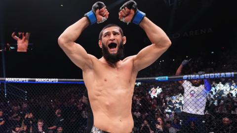 Khamzat Chimaev shouts to the crowd in the octagon