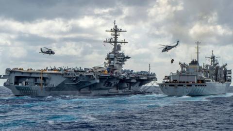 Handout picture released by the US Navy on 8 May 2019 shows the Nimitz-class aircraft carrier USS Abraham Lincoln being replenished at sea by the fast combat support ship USNS Arctic (T-AOE 9)