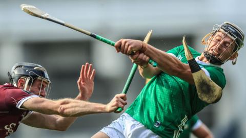 Galway's Padraic Mannion has his hurley broken as he challenges Limerick's Gearoid Hegarty